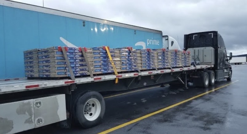 Flatbed truck carrying secured construction materials